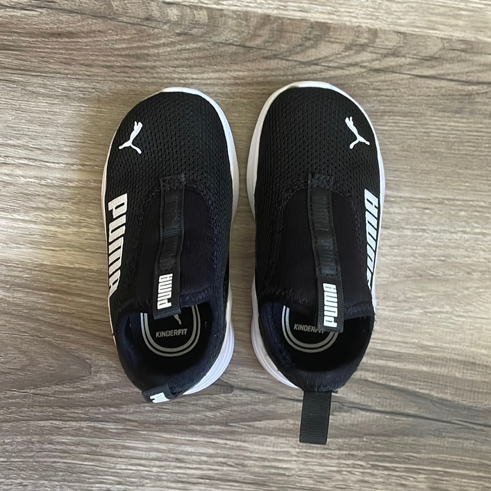 Size 6C like-new Puma black slip-on tennis shoes